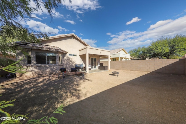 back of house featuring a patio area and an outdoor fire pit