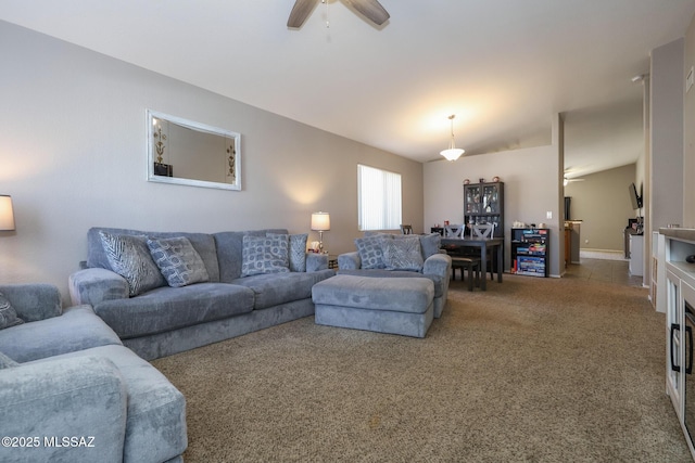 carpeted living room with ceiling fan