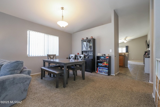 carpeted dining room featuring ceiling fan