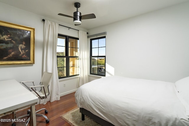 bedroom featuring ceiling fan and dark hardwood / wood-style floors