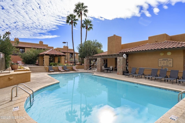 view of swimming pool with a patio