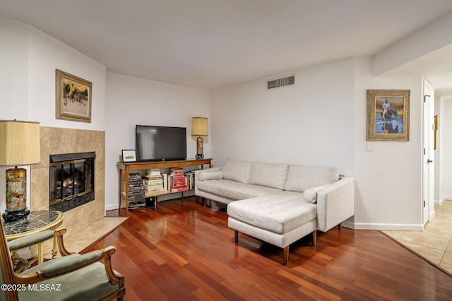 living room with a fireplace and hardwood / wood-style flooring