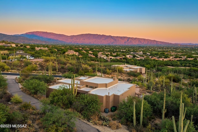 aerial view at dusk featuring a mountain view