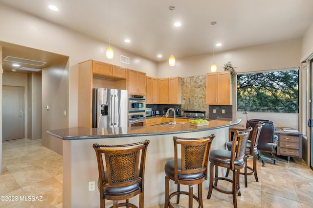 kitchen with backsplash, sink, decorative light fixtures, and appliances with stainless steel finishes