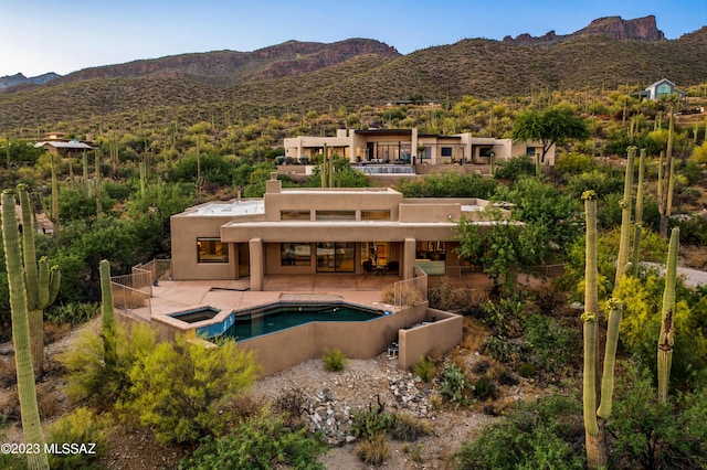 exterior space with a mountain view and a patio