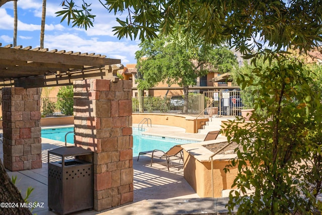 view of swimming pool featuring a pergola