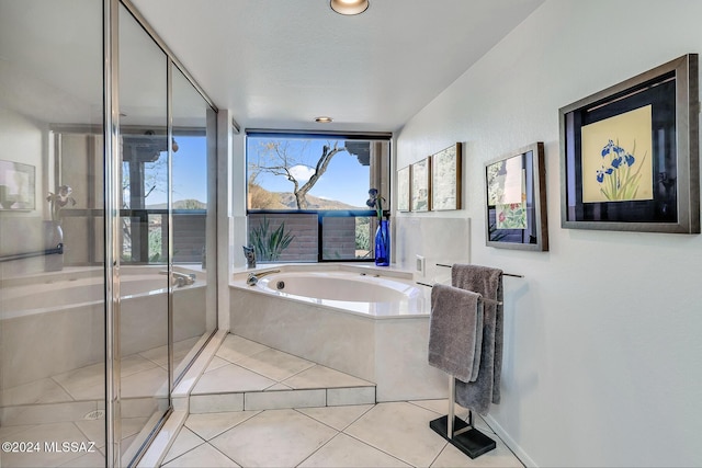 bathroom featuring tile patterned floors and independent shower and bath