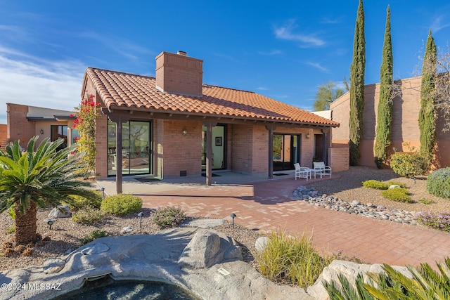 back of property with a patio