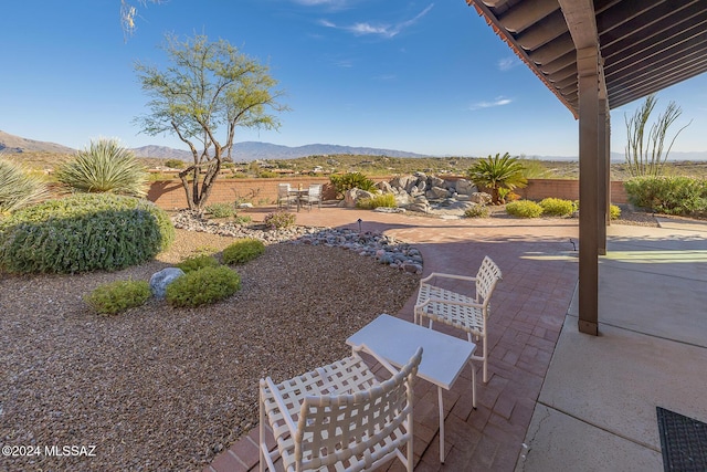 view of yard with a mountain view and a patio area