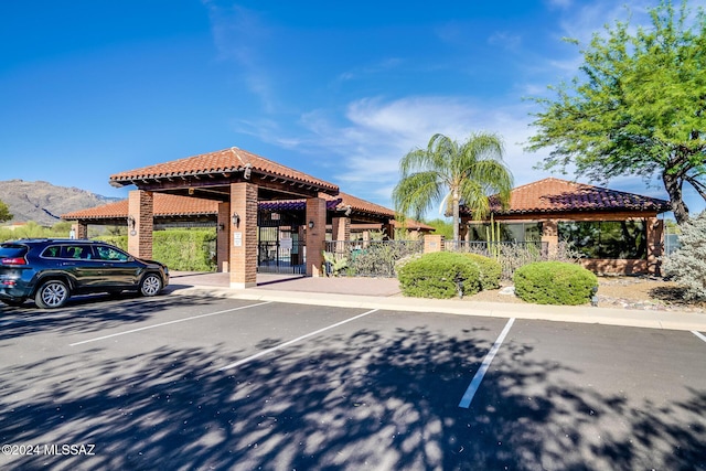 view of parking with a mountain view and a gazebo