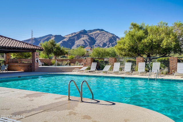 view of pool featuring a mountain view and a patio area