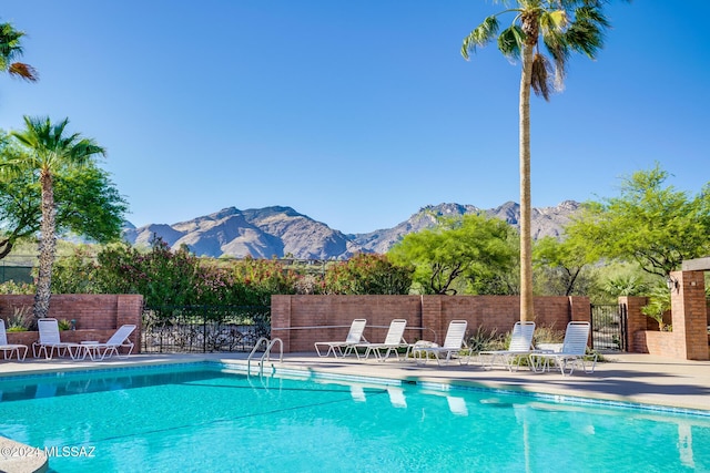 view of swimming pool with a mountain view