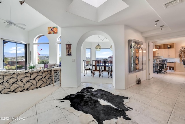 interior space featuring ceiling fan and light tile patterned floors