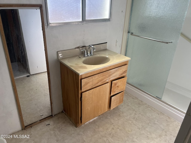 bathroom featuring vanity and a shower with shower door