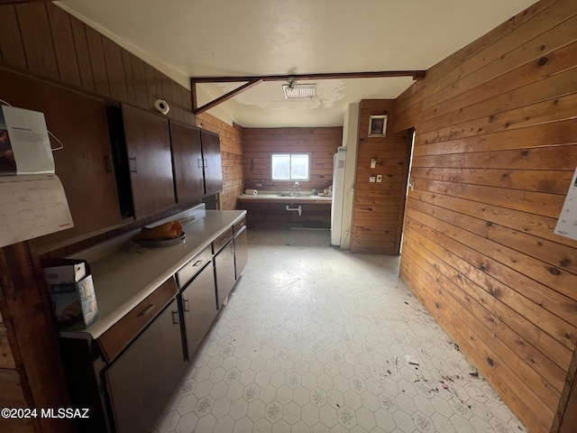 bathroom featuring sink and wooden walls