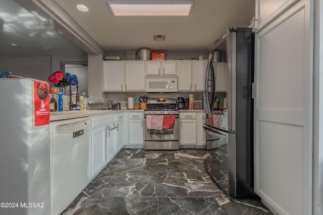 kitchen with white cabinetry and appliances with stainless steel finishes