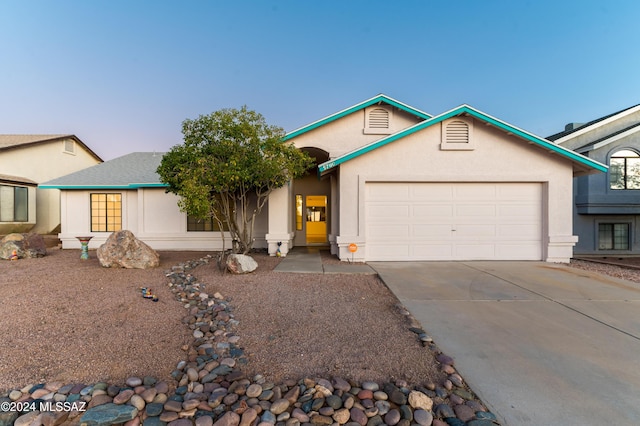 ranch-style home featuring a garage