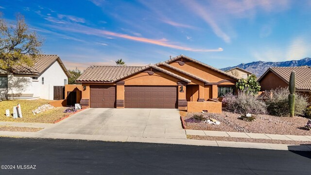 view of front of house with a mountain view and a garage