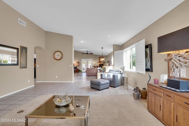 tiled living room featuring vaulted ceiling and ceiling fan