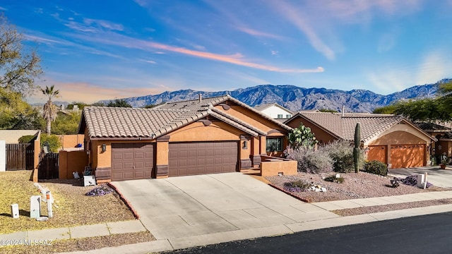 ranch-style home with a mountain view and a garage