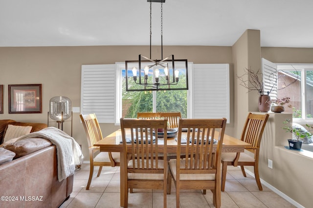 dining area with light tile patterned floors and an inviting chandelier