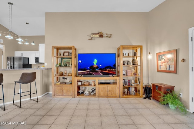 living room featuring light tile patterned floors and high vaulted ceiling