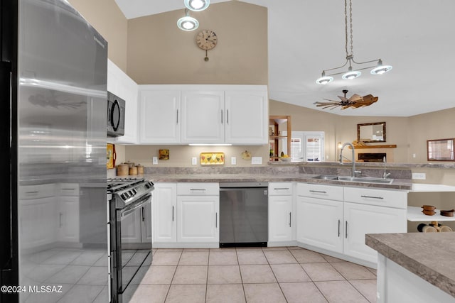 kitchen with stainless steel appliances, ceiling fan, sink, pendant lighting, and white cabinets