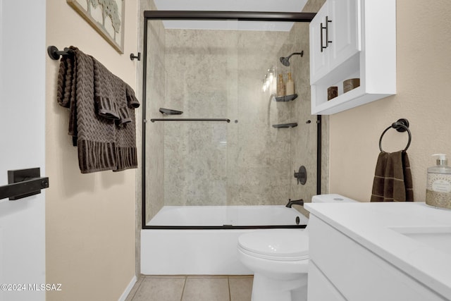 full bathroom with shower / bath combination with glass door, vanity, tile patterned floors, and toilet