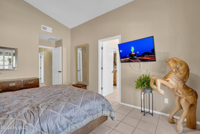 bedroom featuring light tile patterned floors and vaulted ceiling