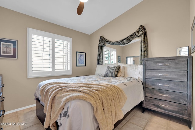 tiled bedroom featuring ceiling fan and lofted ceiling