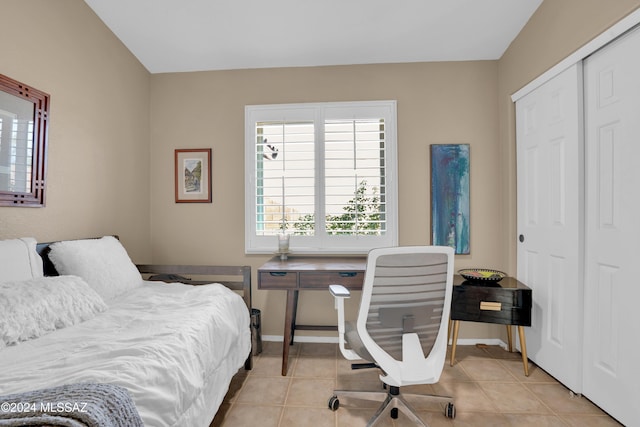 bedroom featuring a closet and light tile patterned flooring