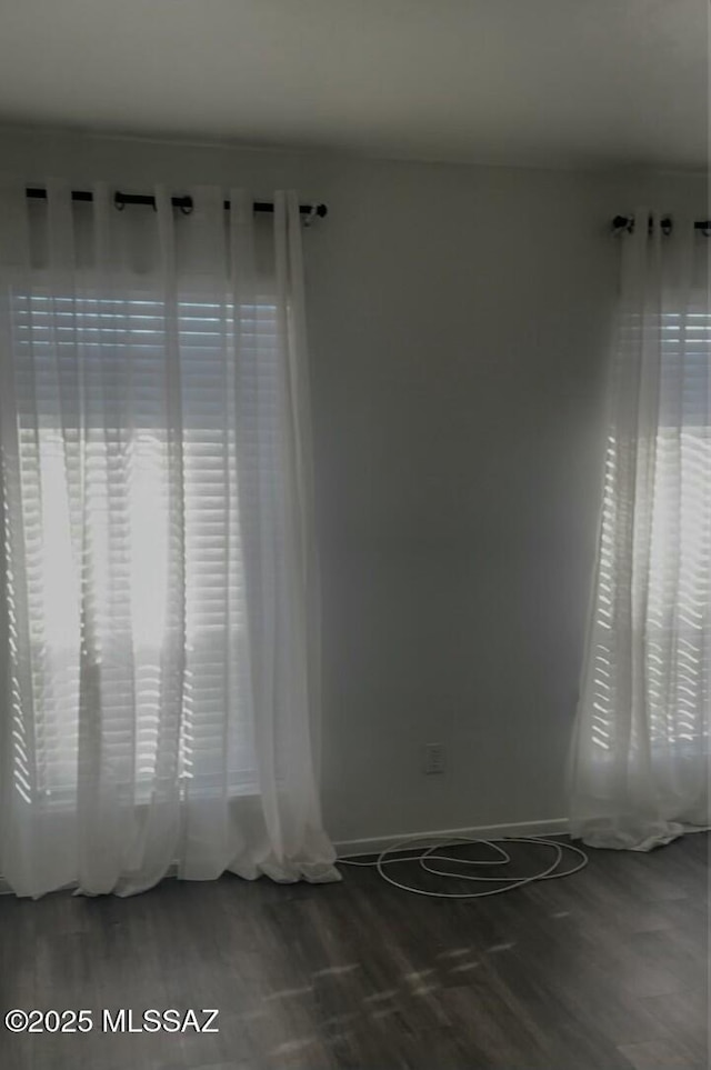 empty room featuring plenty of natural light and hardwood / wood-style floors