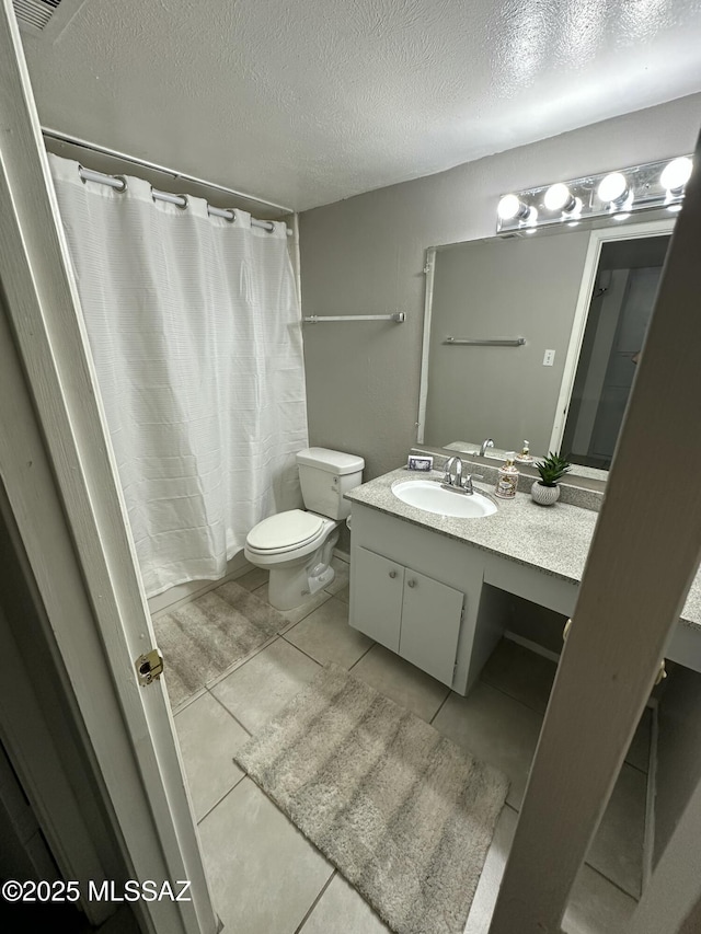 bathroom featuring vanity, a textured ceiling, toilet, and a shower with shower curtain