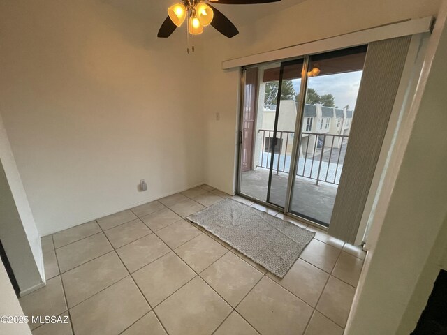 unfurnished living room with ceiling fan, light tile patterned floors, and a fireplace