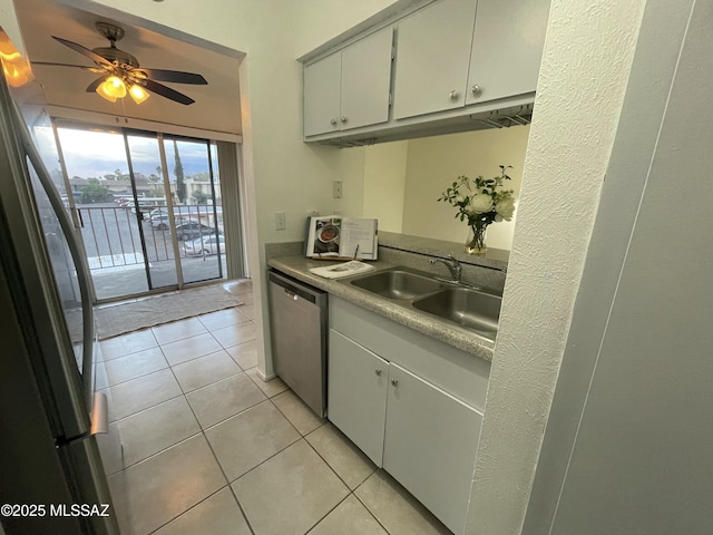 kitchen featuring a sink, freestanding refrigerator, light tile patterned floors, dishwasher, and ceiling fan