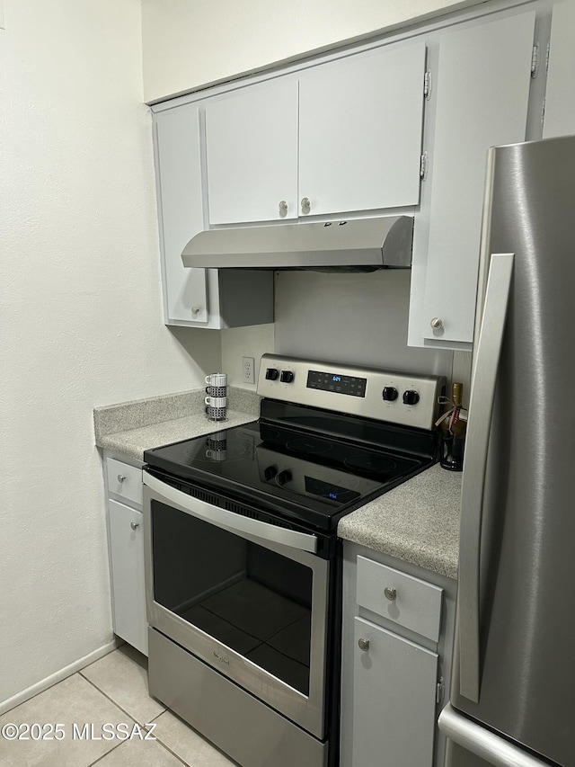 kitchen with white cabinetry, light tile patterned floors, and stainless steel appliances