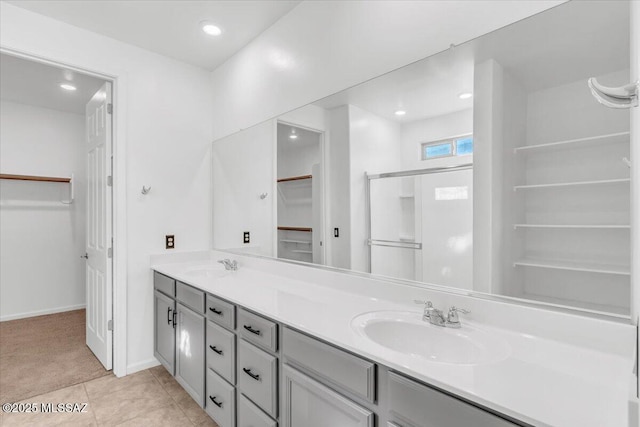 bathroom featuring vanity, tile patterned floors, and a shower with shower door