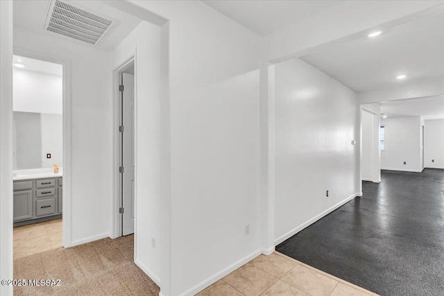 hall with light tile patterned floors