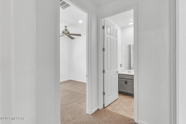 corridor with light colored carpet