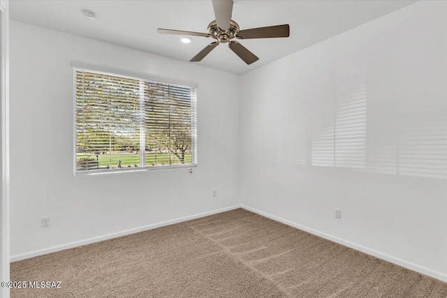 spare room with carpet and ceiling fan