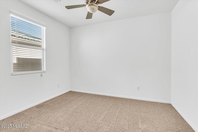 carpeted spare room with ceiling fan