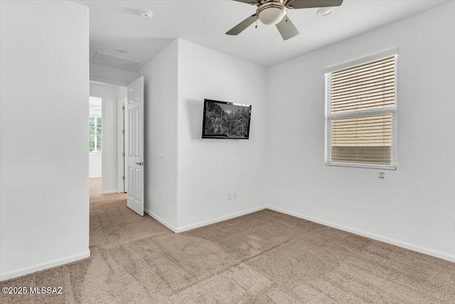 unfurnished room with light carpet and ceiling fan