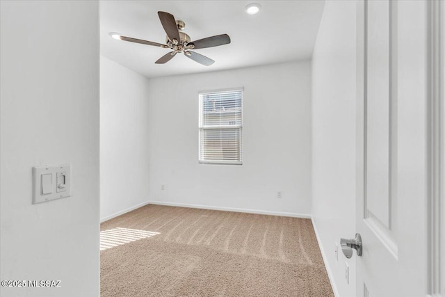 empty room with ceiling fan and carpet floors