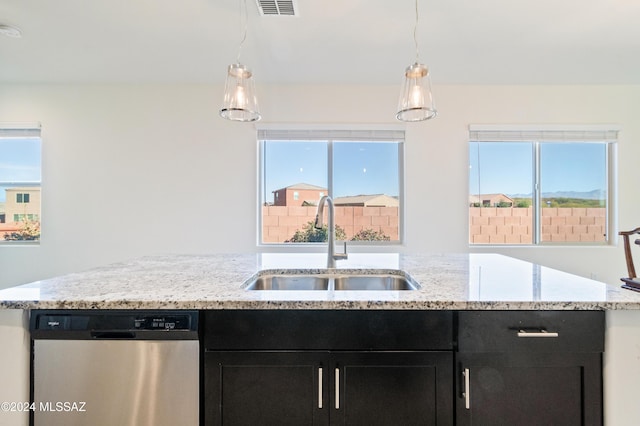 kitchen with a wealth of natural light, dishwasher, hanging light fixtures, and sink