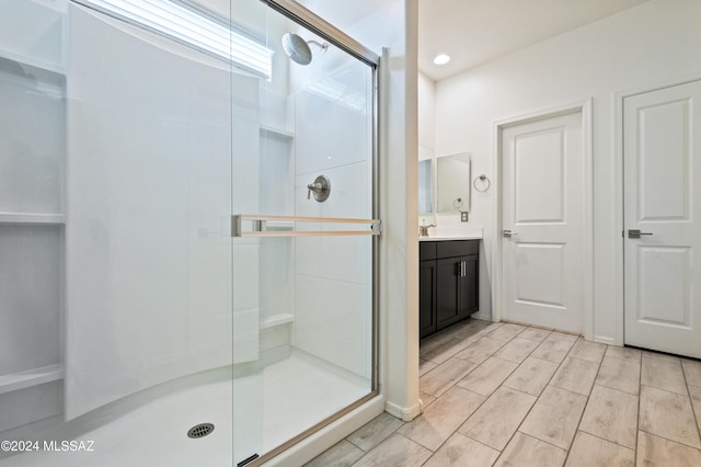 bathroom featuring vanity and an enclosed shower