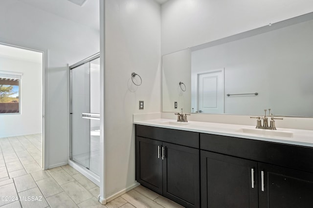 bathroom with a shower with door and vanity