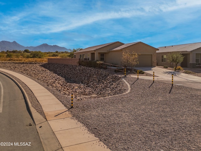 ranch-style house with a mountain view and a garage