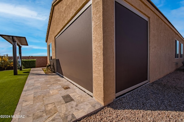 view of home's exterior with a lawn and a patio area