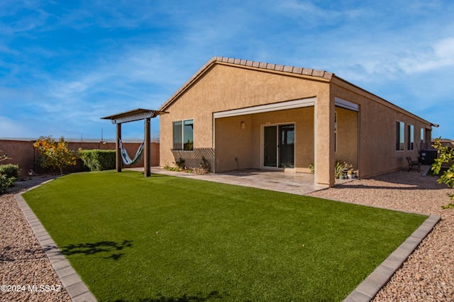 back of property with a lawn and a patio