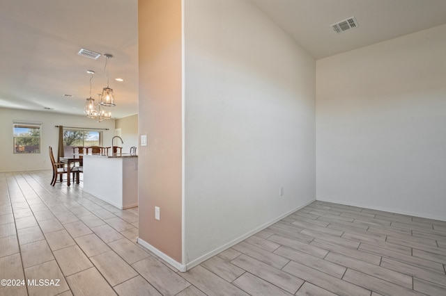 empty room featuring a chandelier